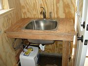 Water Heater Being Installed Under Downstairs Sink, May 11, 2010