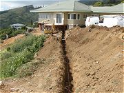 Trench for Six Inch Gutter Pipe to Catchment Water Tank.  June 11, 2009